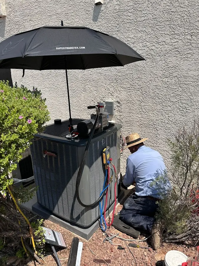 HVAC technician performing outdoor AC maintenance in Payson